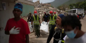 Families wait outside a temporary morgue following Venezuela's deadly earthquakes. - AP Photo/Matias Delacroix