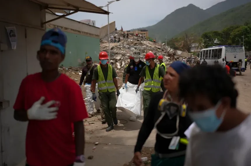 Families wait outside a temporary morgue following Venezuela's deadly earthquakes. - AP Photo/Matias Delacroix