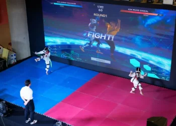 Athlete competing in Virtual Taekwondo using VR headset and motion sensors - AP Photo/Vincent Thian