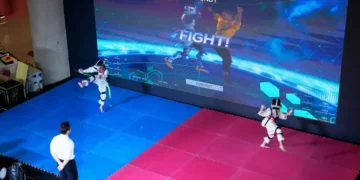 Athlete competing in Virtual Taekwondo using VR headset and motion sensors - AP Photo/Vincent Thian