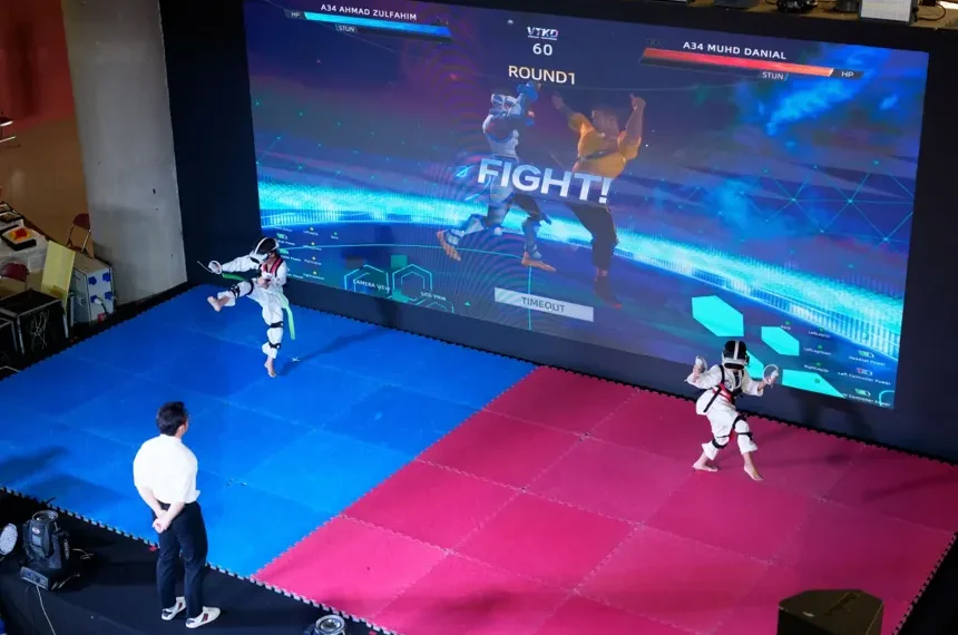Athlete competing in Virtual Taekwondo using VR headset and motion sensors - AP Photo/Vincent Thian