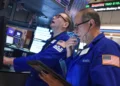 Traders monitor Wall Street as technology stocks lead market declines. - AP Photo/Richard Drew