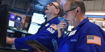 Traders monitor Wall Street as technology stocks lead market declines. - AP Photo/Richard Drew