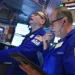 Traders monitor Wall Street as technology stocks lead market declines. - AP Photo/Richard Drew
