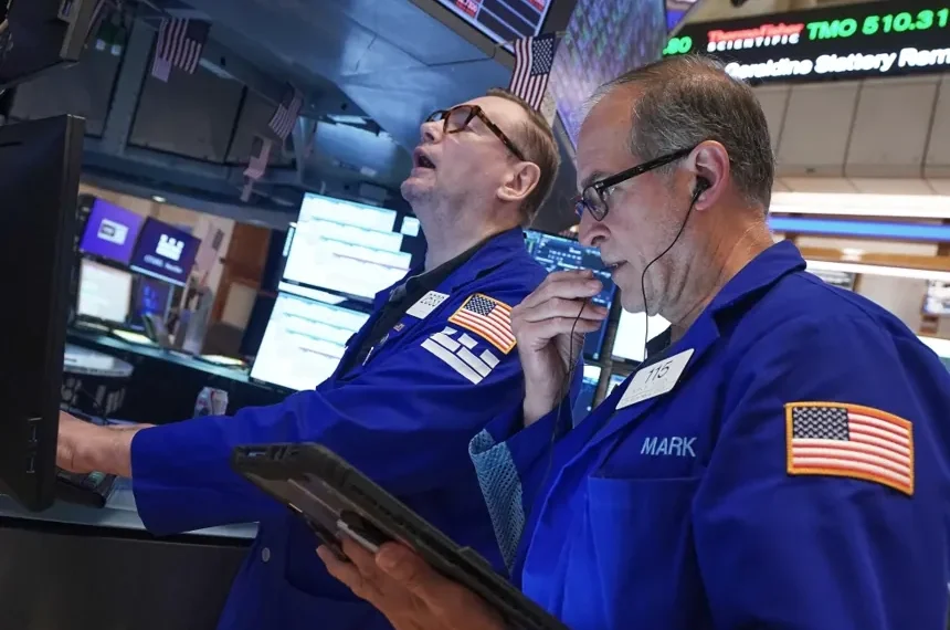 Traders monitor Wall Street as technology stocks lead market declines. - AP Photo/Richard Drew
