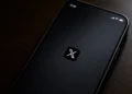Screenshot of the X mobile application splash screen displayed on a smartphone, showing the X logo centered on a dark startup screen.
