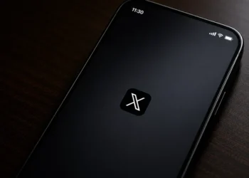 Screenshot of the X mobile application splash screen displayed on a smartphone, showing the X logo centered on a dark startup screen.