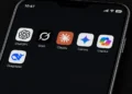 Mobile screen captured by JournosNews displaying ChatGPT, Grok, Claude, Gemini, Copilot and DeepSeek AI applications.