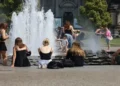 People cool off in the fountain at Berlin's Lustgarten during a summer heatwave in Germany.