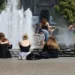 People cool off in the fountain at Berlin's Lustgarten during a summer heatwave in Germany.