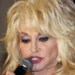 Dolly Parton posing for a photograph during a 2011 public appearance.