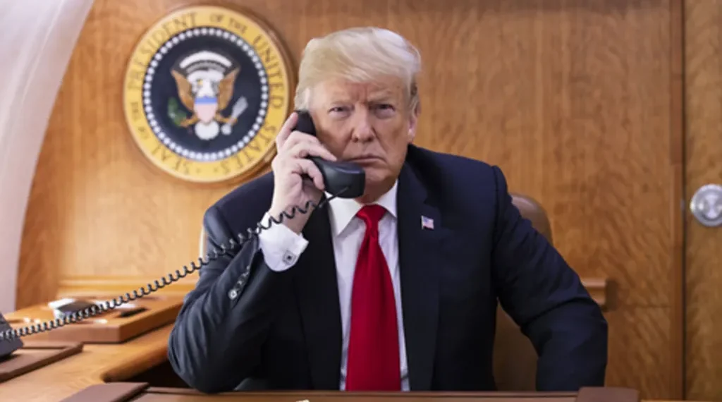 President Donald J. Trump speaks on the phone aboard Air Force One during a Hurricane Michael impact update in October 2018.