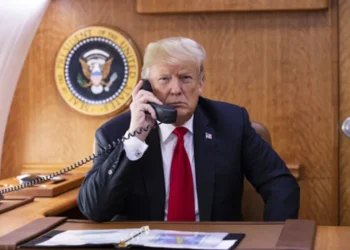 President Donald J. Trump speaks on the phone aboard Air Force One during a Hurricane Michael impact update in October 2018.