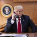 President Donald J. Trump speaks on the phone aboard Air Force One during a Hurricane Michael impact update in October 2018.