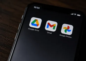 Close-up of a smartphone screen displaying the Google Drive, Gmail and Google Photos app icons against a dark background.