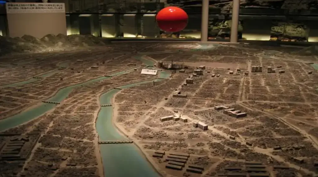 Diorama at Hiroshima Peace Memorial Museum showing the city after the atomic bomb blast, with a red marker indicating the blast location.