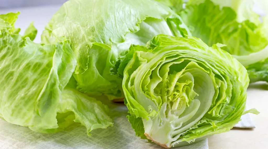 Fresh iceberg lettuce displayed for sale at a grocery store during the CDC investigation into a multistate Cyclospora outbreak linked to recalled lettuce.