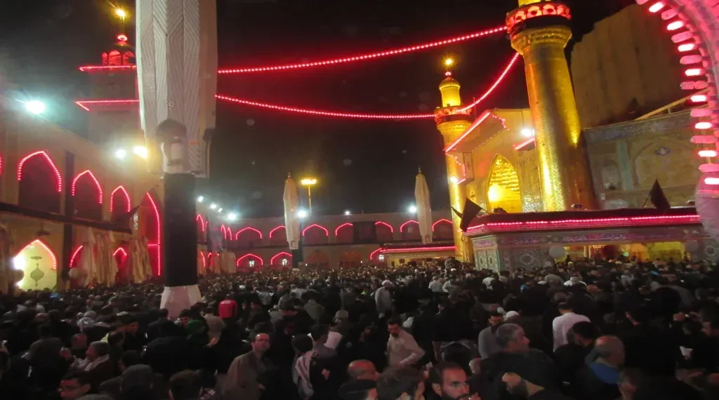 Pilgrims gather around the illuminated Imam Ali Shrine in Najaf, Iraq, during the annual Arbaeen pilgrimage, one of the world's largest religious gatherings.