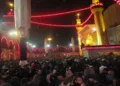 Pilgrims gather around the illuminated Imam Ali Shrine in Najaf, Iraq, during the annual Arbaeen pilgrimage, one of the world's largest religious gatherings.