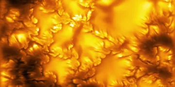 High-resolution image of the Sun's photosphere captured by the NSF Daniel K. Inouye Solar Telescope, revealing fine magnetic structures and plasma patterns linked to Kelvin-Helmholtz instability.