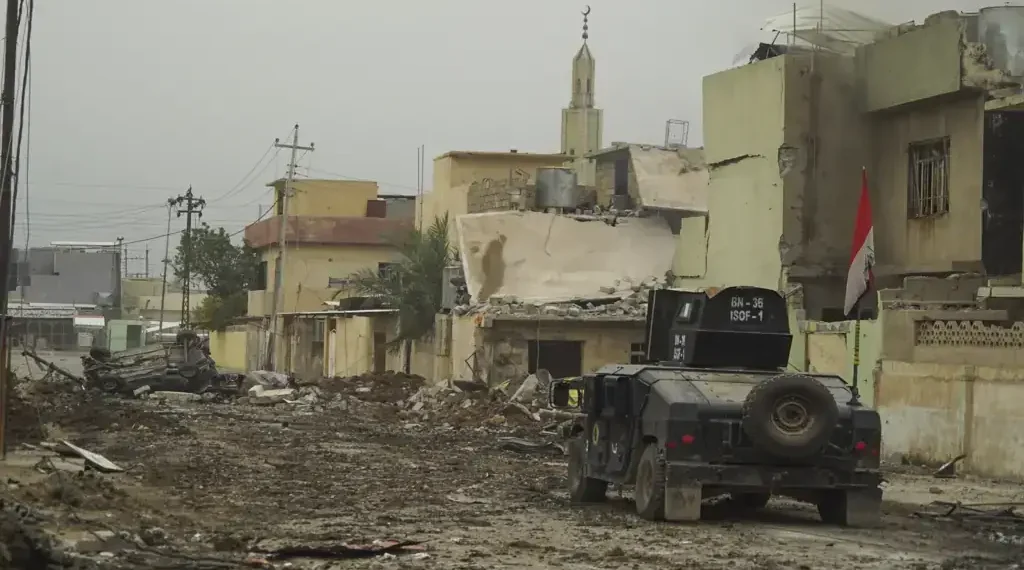 An Iraqi Special Operations Forces armored personnel carrier drives along a street in Mosul during the battle against Islamic State forces.