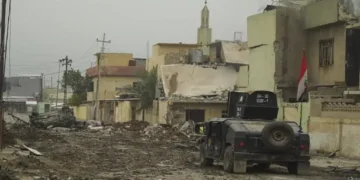 An Iraqi Special Operations Forces armored personnel carrier drives along a street in Mosul during the battle against Islamic State forces.