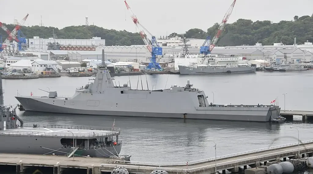 Japan Maritime Self-Defense Force frigate JS Mogami (FFM-1) moored at Yokosuka Naval Base, viewed from the left rear during a port visit.