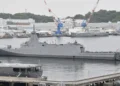 Japan Maritime Self-Defense Force frigate JS Mogami (FFM-1) moored at Yokosuka Naval Base, viewed from the left rear during a port visit.