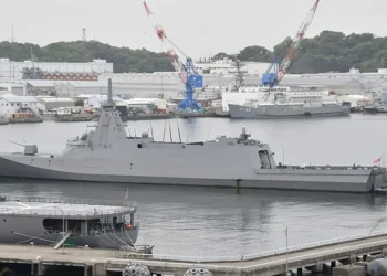 Japan Maritime Self-Defense Force frigate JS Mogami (FFM-1) moored at Yokosuka Naval Base, viewed from the left rear during a port visit.