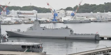 Japan Maritime Self-Defense Force frigate JS Mogami (FFM-1) moored at Yokosuka Naval Base, viewed from the left rear during a port visit.