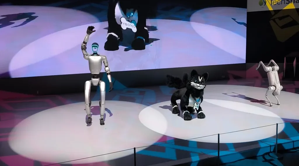 Unitree G1 humanoid robot, VISIONOID FOX animanoid and Unitree Go2 robot dog displayed at Japan Mobility Show 2025 in Tokyo.