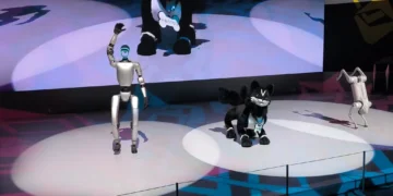 Unitree G1 humanoid robot, VISIONOID FOX animanoid and Unitree Go2 robot dog displayed at Japan Mobility Show 2025 in Tokyo.