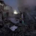 Firefighters from Ukraine's State Emergency Service work among the rubble of a severely damaged building as smoke rises following a Russian attack in Kyiv.