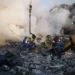 Emergency responders from Ukraine's State Emergency Service work at the scene of damage following a Russian attack in Kyiv.
