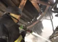 Emergency responders inspect damage after a Russian mass attack on Kyiv, with casualties and destruction reported by Ukraine's emergency service.