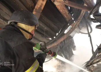 Emergency responders inspect damage after a Russian mass attack on Kyiv, with casualties and destruction reported by Ukraine's emergency service.