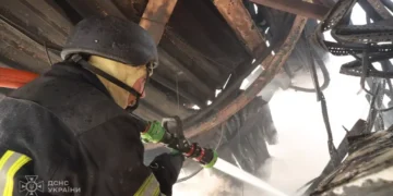 Emergency responders inspect damage after a Russian mass attack on Kyiv, with casualties and destruction reported by Ukraine's emergency service.