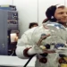 Apollo 11 Commander Neil Armstrong prepares to put on his space helmet with assistance from a technician before the historic Moon mission launch.