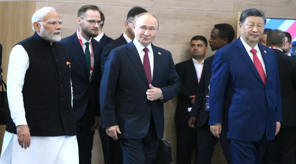 Russian President Vladimir Putin stands with Indian Prime Minister Narendra Modi and Chinese leader Xi Jinping before a BRICS Summit meeting.