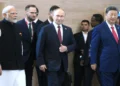 Russian President Vladimir Putin stands with Indian Prime Minister Narendra Modi and Chinese leader Xi Jinping before a BRICS Summit meeting.