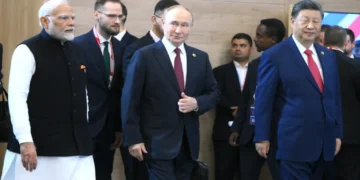 Russian President Vladimir Putin stands with Indian Prime Minister Narendra Modi and Chinese leader Xi Jinping before a BRICS Summit meeting.