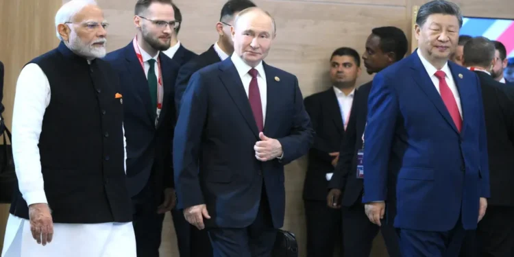 Russian President Vladimir Putin stands with Indian Prime Minister Narendra Modi and Chinese leader Xi Jinping before a BRICS Summit meeting.