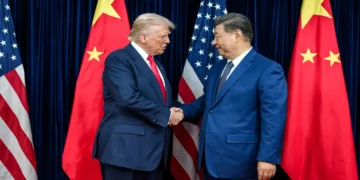 U.S. President Donald Trump greets Chinese leader Xi Jinping before a bilateral meeting in Busan, South Korea.