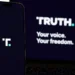 Truth Social branding displayed on a smartphone beside a laptop showing the platform's desktop interface.
