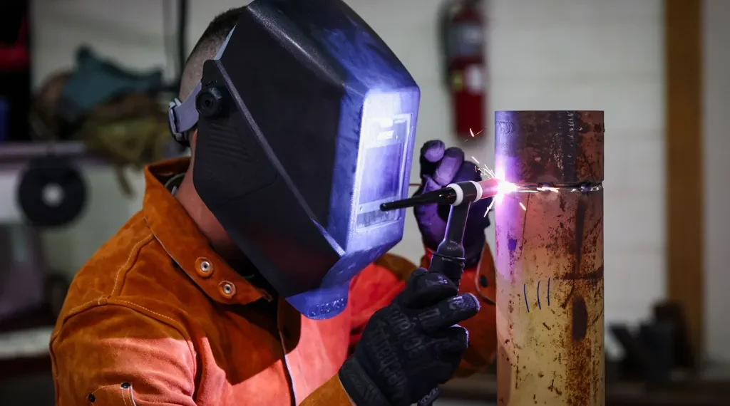 U.S. Army Staff Sgt. Allen Kemper welds metal pipes at the ARCENT Innovation and Manufacturing Center in Kuwait during manufacturing operations.