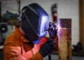 U.S. Army Staff Sgt. Allen Kemper welds metal pipes at the ARCENT Innovation and Manufacturing Center in Kuwait during manufacturing operations.