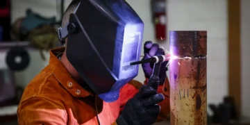 U.S. Army Staff Sgt. Allen Kemper welds metal pipes at the ARCENT Innovation and Manufacturing Center in Kuwait during manufacturing operations.