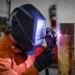U.S. Army Staff Sgt. Allen Kemper welds metal pipes at the ARCENT Innovation and Manufacturing Center in Kuwait during manufacturing operations.