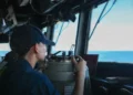 A U.S. sailor stands watch on the bridge of the guided-missile destroyer USS John Finn (DDG 113) during Operation Epic Fury in the U.S. 5th Fleet area of responsibility.