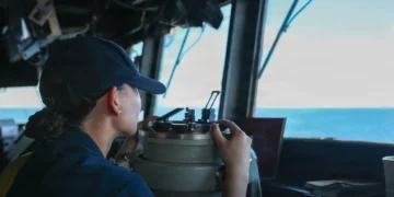 A U.S. sailor stands watch on the bridge of the guided-missile destroyer USS John Finn (DDG 113) during Operation Epic Fury in the U.S. 5th Fleet area of responsibility.